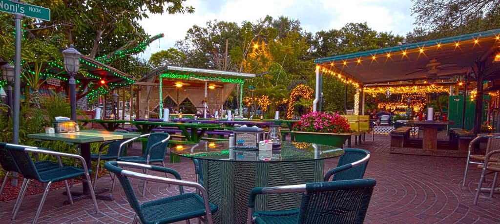 Outdoor tables and string lights in The Chattaway courtyard at dusk.